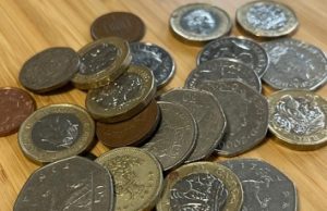 Small pile of coins on a desk